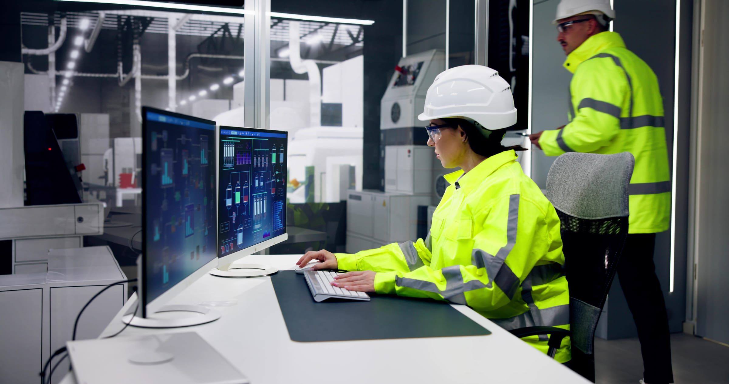 Control room with multiple screens monitoring technical systems